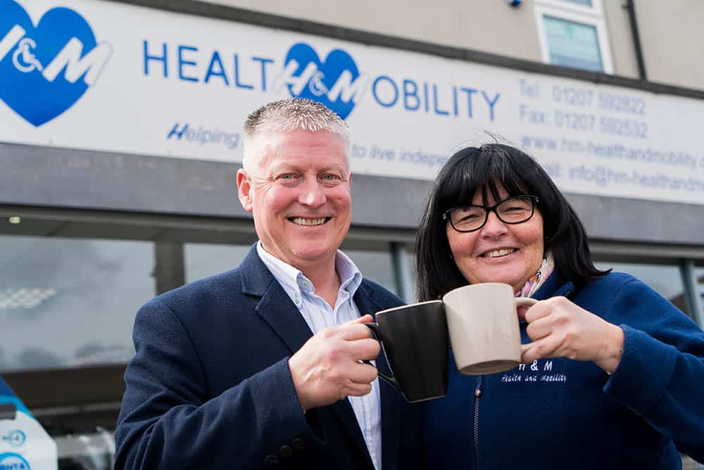 H&M Health & Mobility's Hugh and Yvonne Malone outside shop front