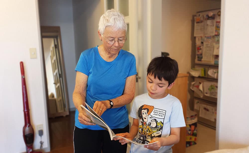 grandmother reading to grandchildren