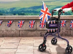 Complete Care Shop's 'Royallator' rollator, covered in Union Jack bunting over looking the countryside.