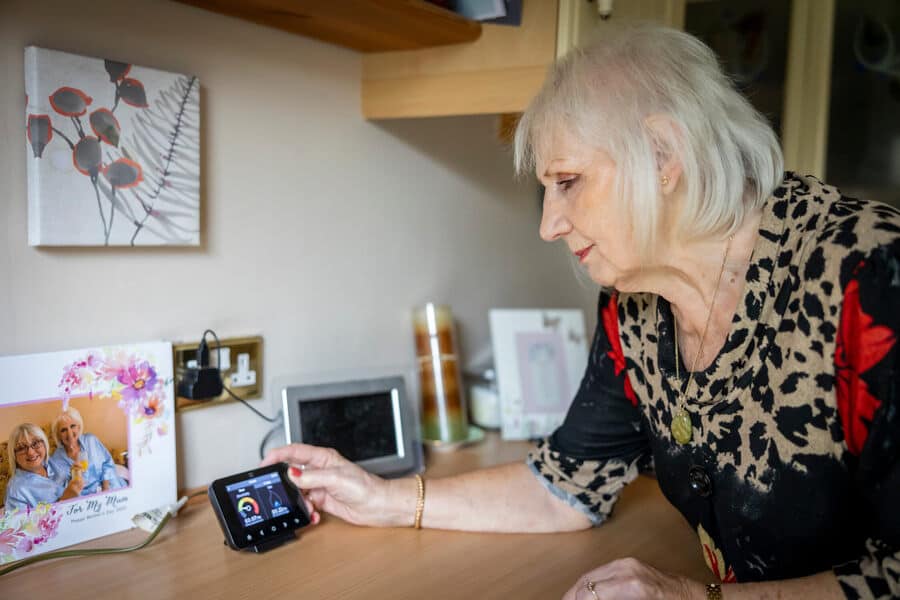 Older lady adjusting smart meter, Ageing Better library
